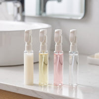 Mova four bottles filled with different liquids on a bathroom counter