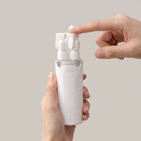Mova pump top dispensing a small dab of lotion