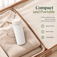 Mova travel dispenser in white packed in a carry-on: compact, phone-sized and travel-ready